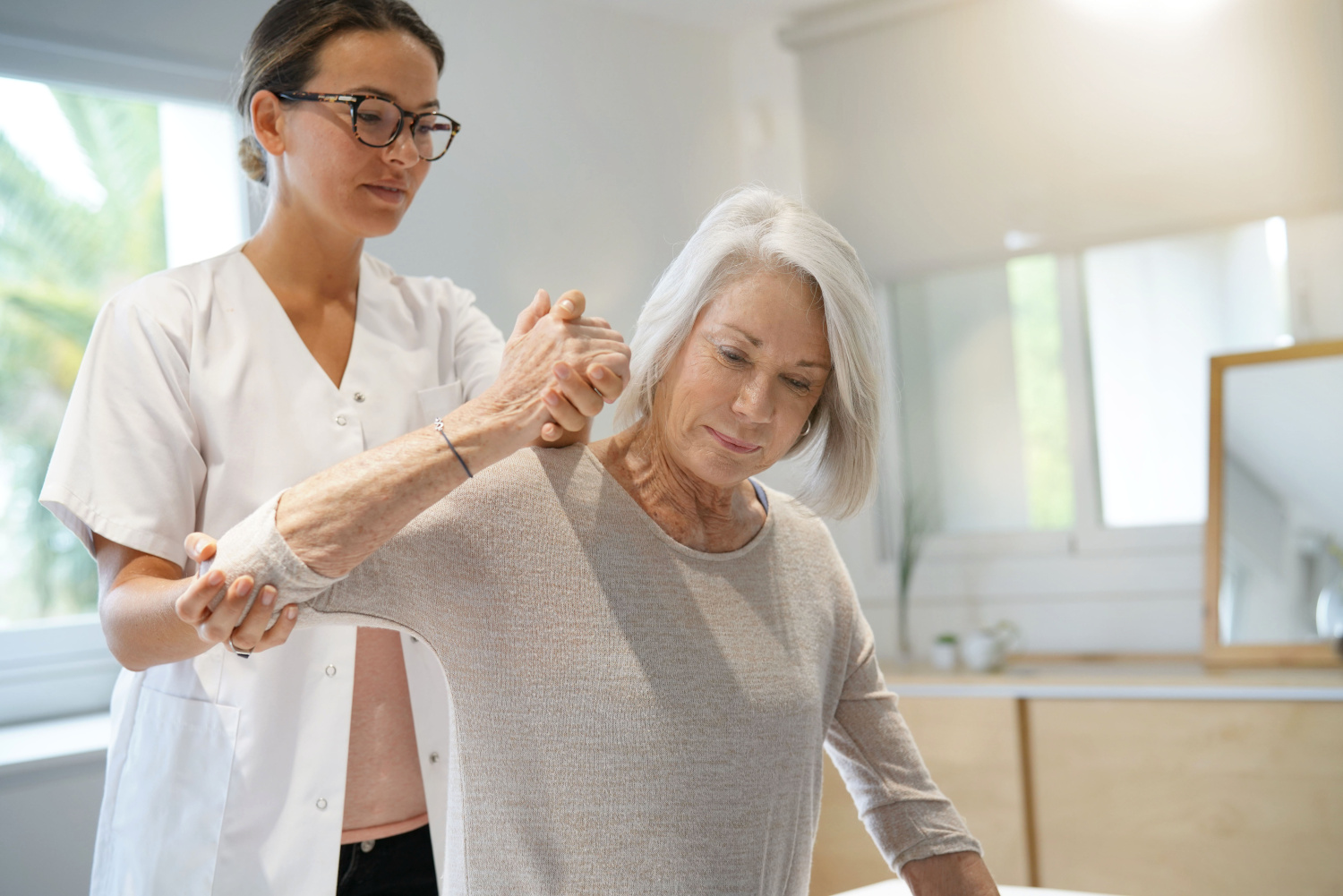 Senior woman with her physiotherapist